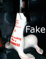 Fake Carlton Ware Guinness seal balancing bottle on nose